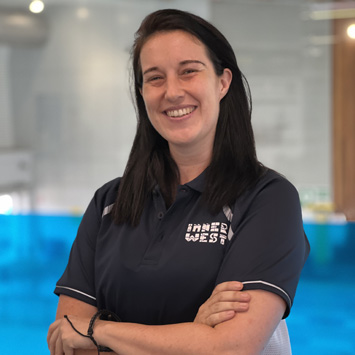 Headshot of personal trainer Sarah smiling with arms crossed